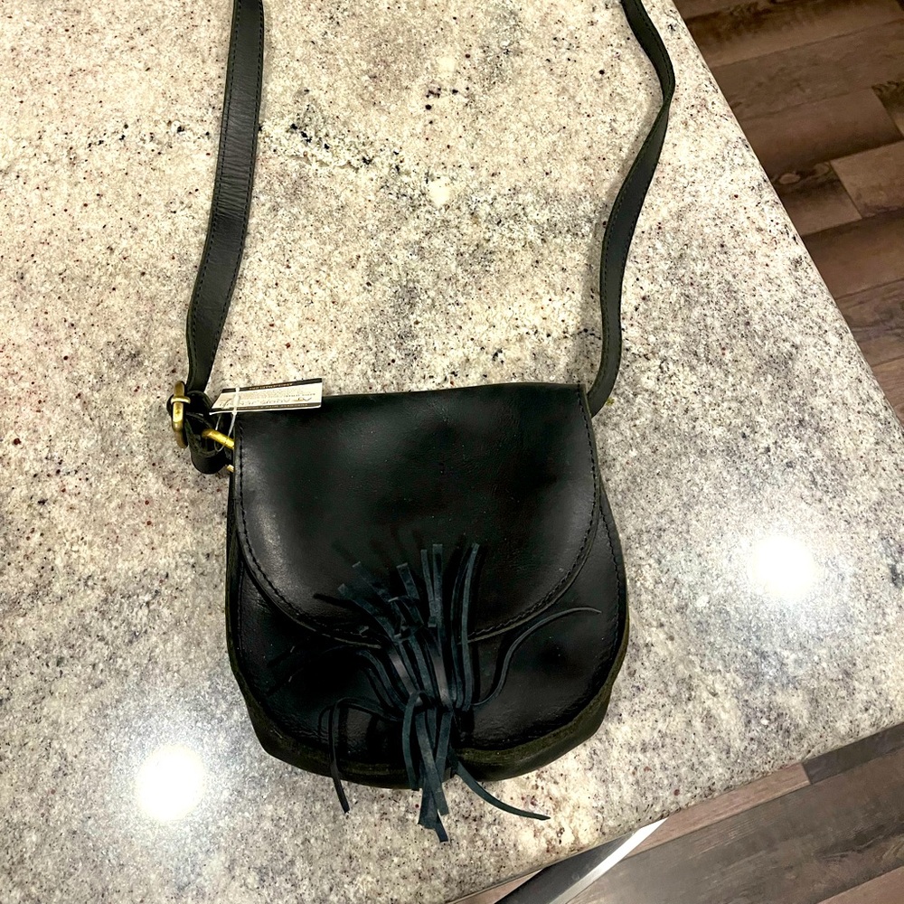 Black crossbody leather purse made in Ethiopia with tassels and snap closure